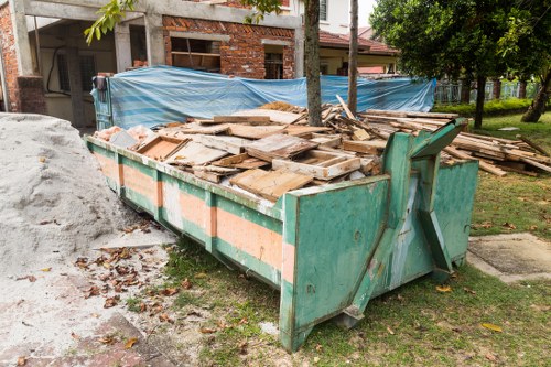 Commercial waste crew unloading bins at a business site