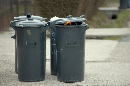 Operative using PPE while handling commercial waste containers